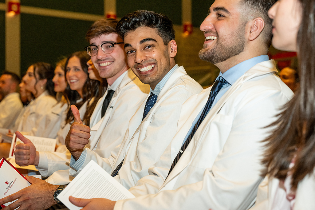 Students in a row, with one giving a thumbs-up