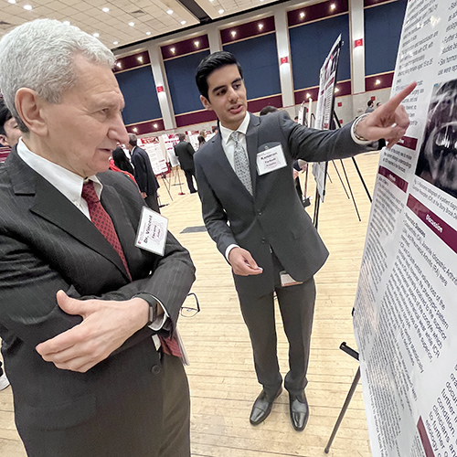 Student Kameron Farhadi presenting to faculty member Dr. Vincent Iacono