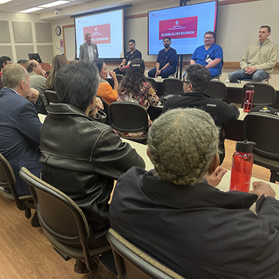 Graduates sit with a student panel for a Q&A session