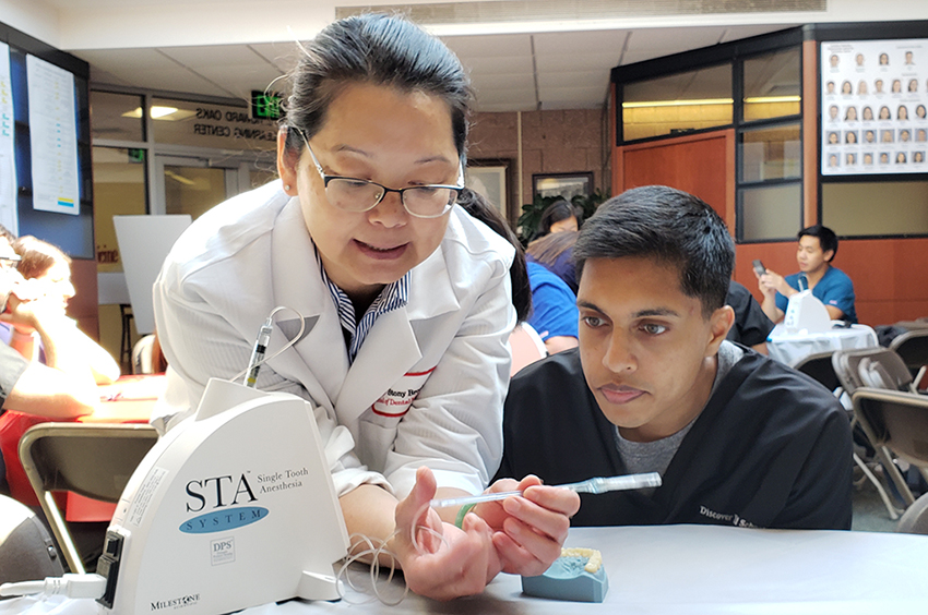 Faculty and student at Discover Dental School